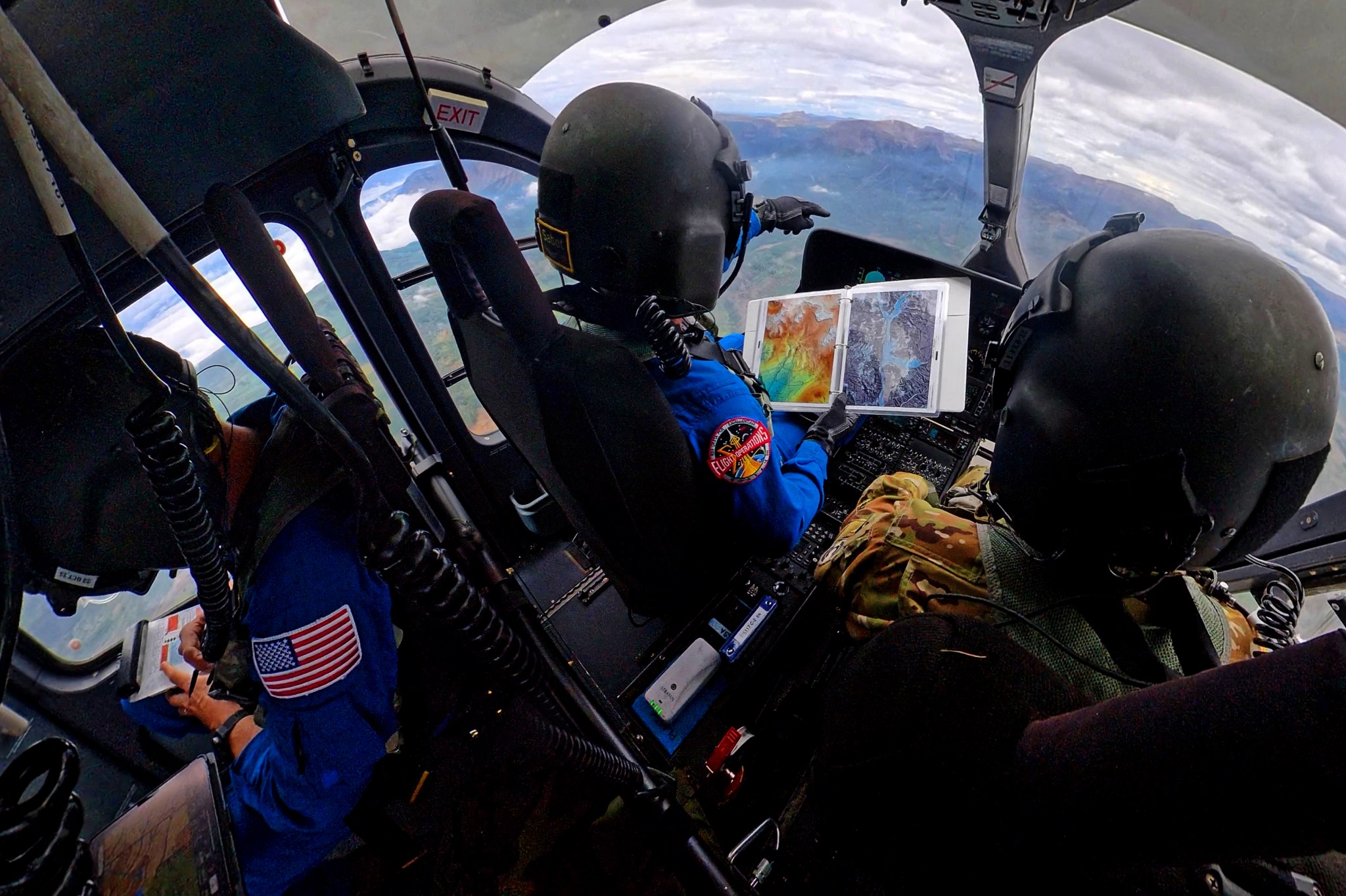 NASA astronauts Matthew Dominick and Mark Vande Hei in a helicopter cockpit.